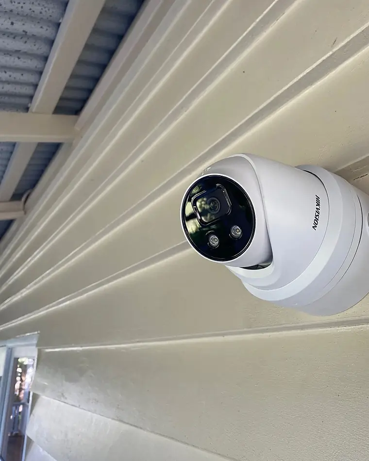 A Hikvision turret camera fixed to an eave