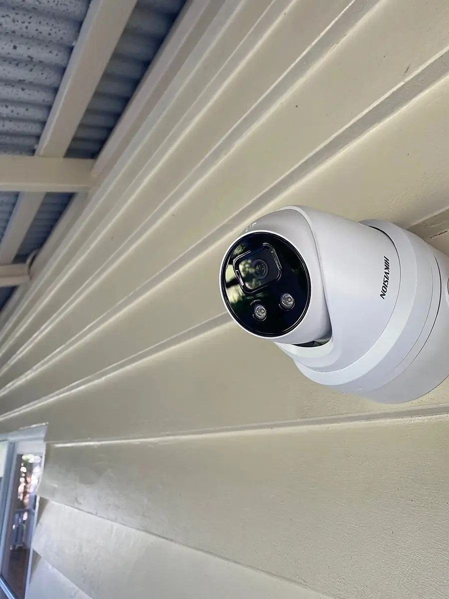 A Hikvision turret camera fixed to an eave